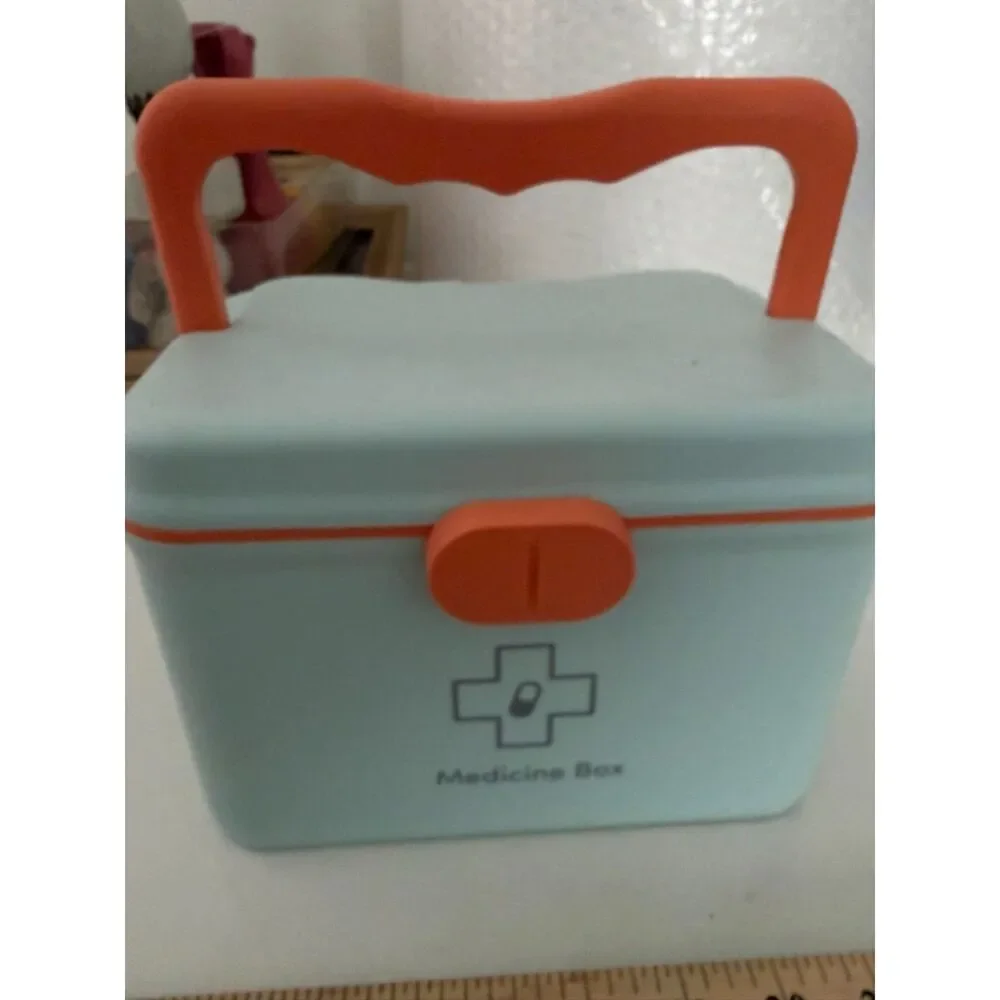 Modern portable plastic medicine box with orange handle and latch